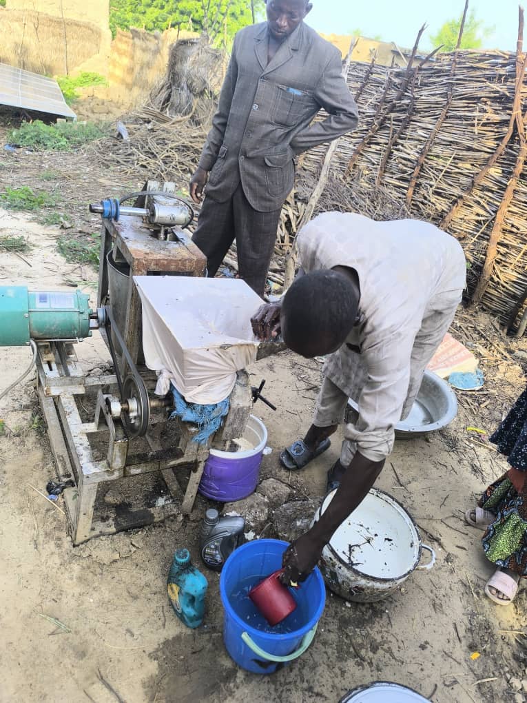 Community member operating a solar-powered mill in the Sahel